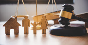 wooden man, woman and child figures with judge's gavel, child custody